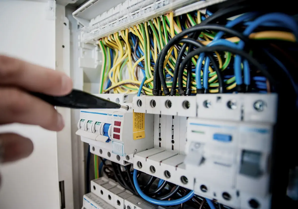 Technician terminating low-voltage wiring